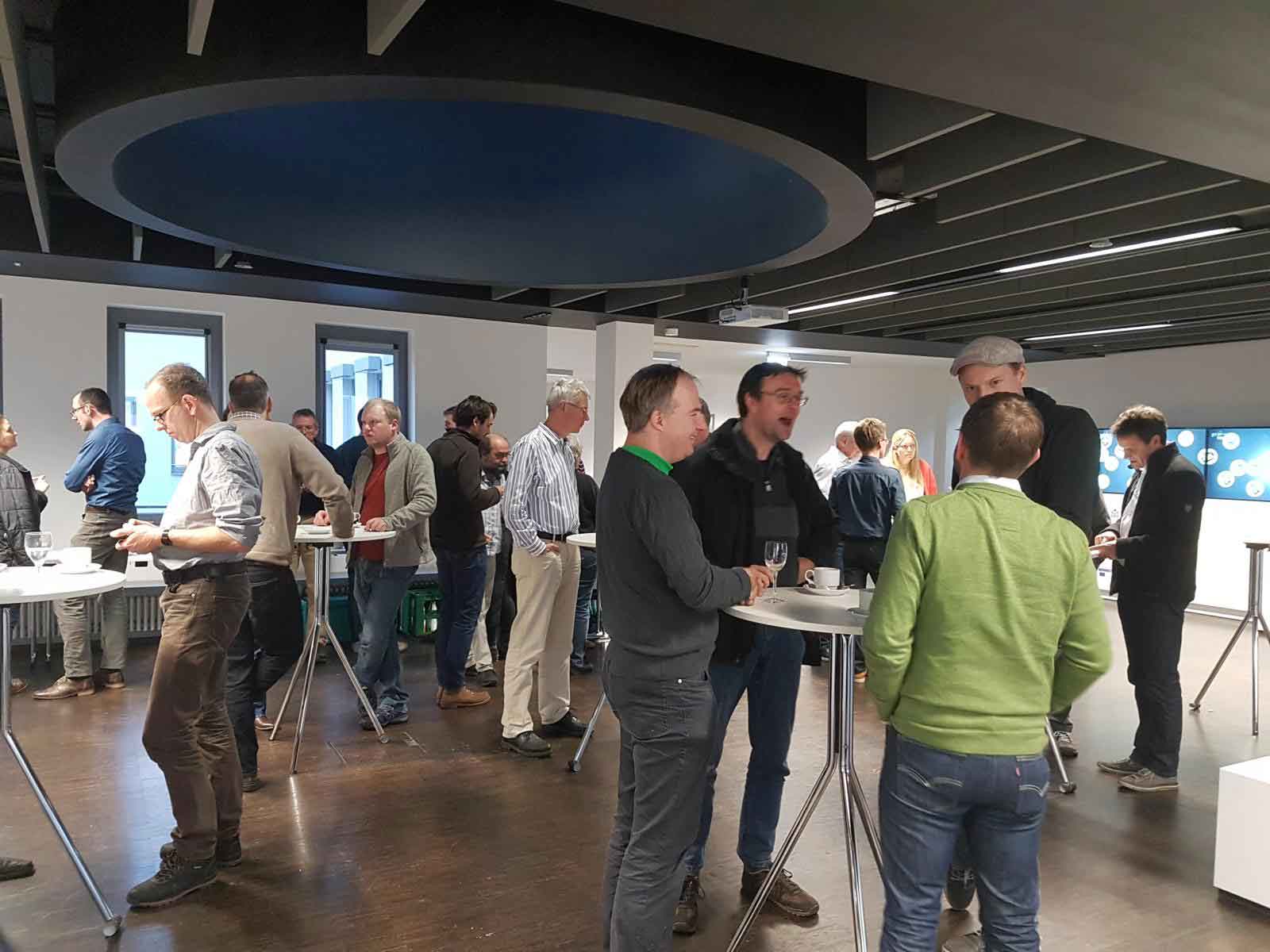 People at standing desks in an atrium