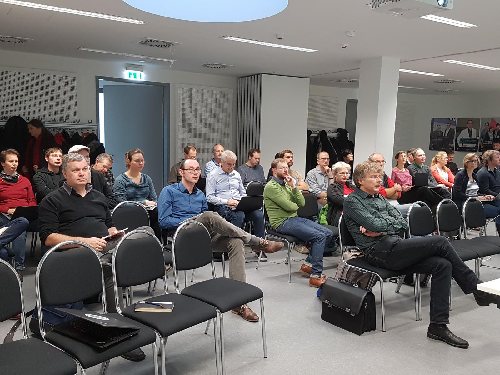 People sitting on chairs in a room