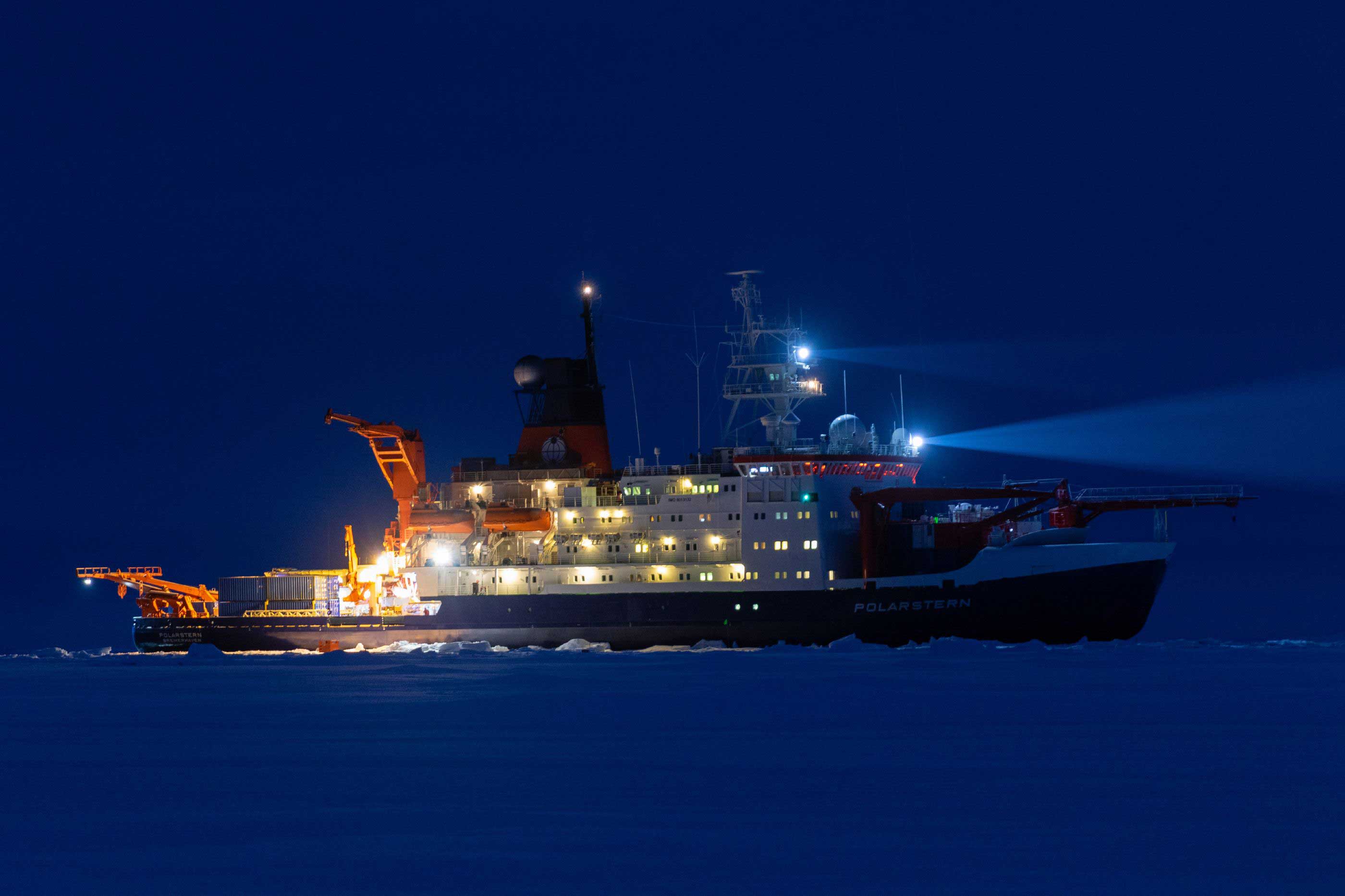The icebreaker Polarstern during polar night in the Arctic lit up by its own lights