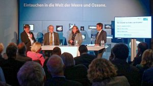 Four people in front of an audience