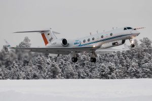 The HALO aircraft at takeoff in a snow landscape