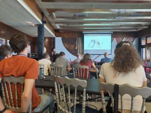 People sitting and looking at a presentation