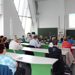 View from the back of a lecture hall with people sitting at desks