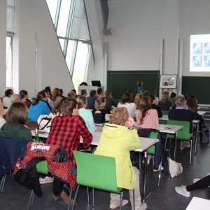 View from the back of a lecture hall with people sitting at desks
