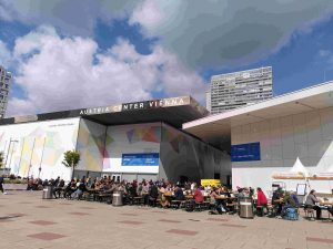 People sitting in front of a conference venue